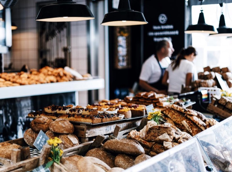 Bakery counter lined with breads and pastries
