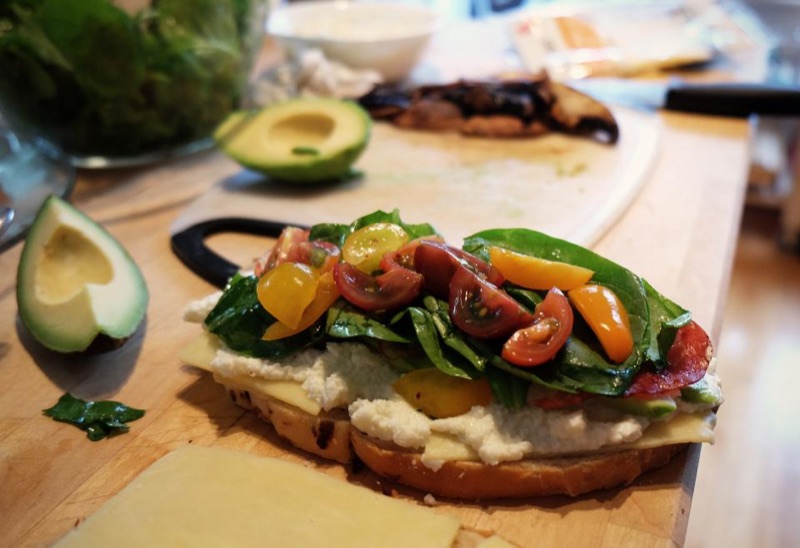 Open-faced sandwich with roasted vegetables and avocado